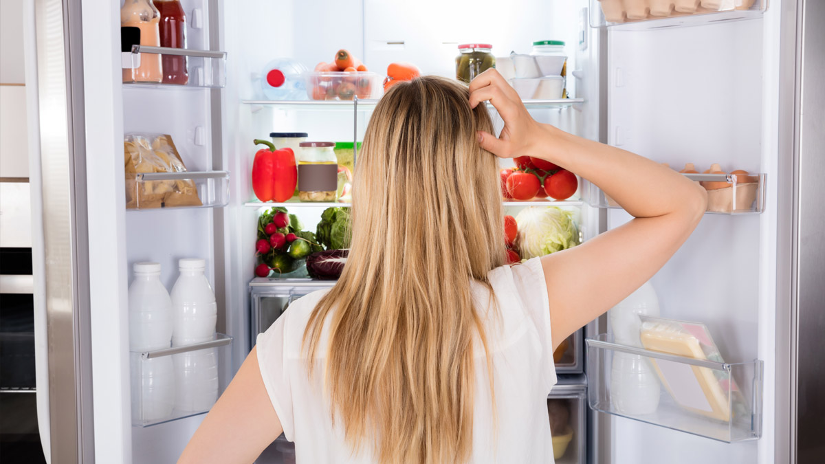 Someone looking for something in the fridge